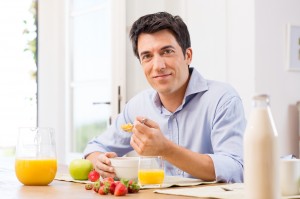 Portrait Of Happy Young Man Having Healthy Breakfast